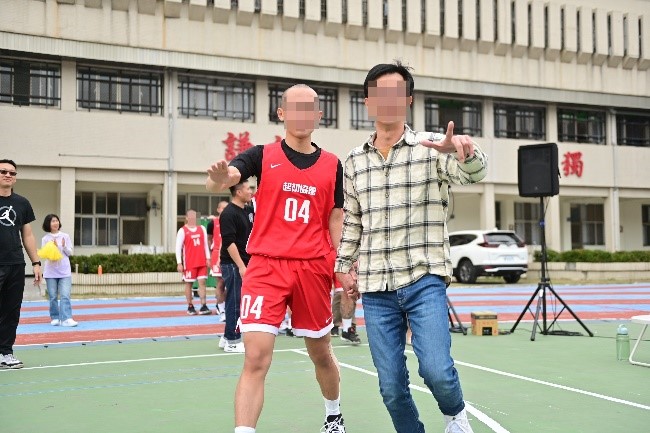 Father holding child's hand on court